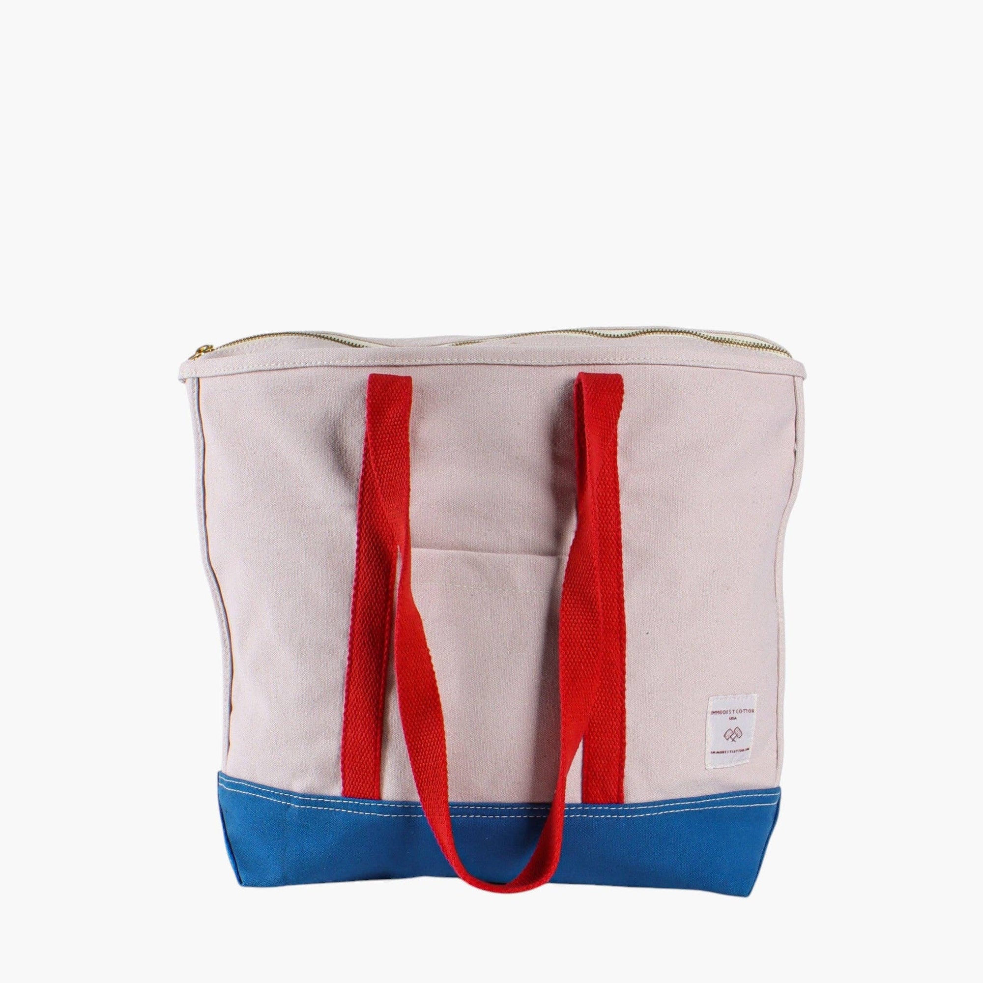 Canvas zipper tote with blue bottom and red shoulder straps 