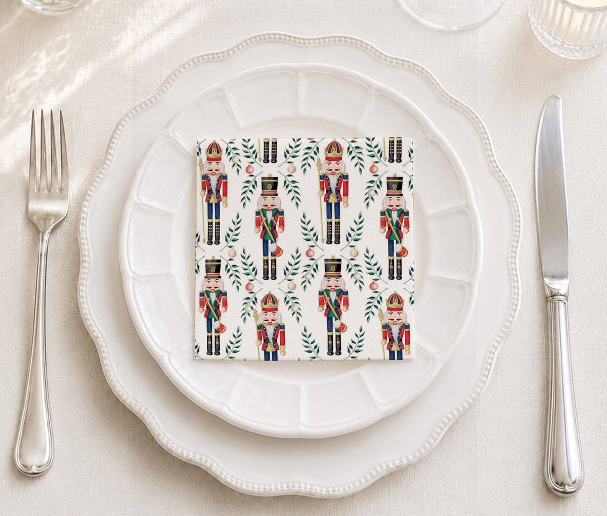 Cocktail napkins with toy soldier design on white plates with flatware 