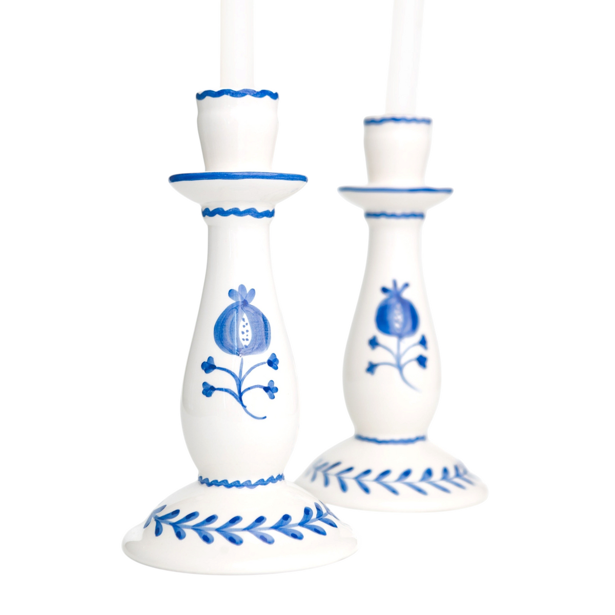 White candle holders with blue floral patterns on a white background