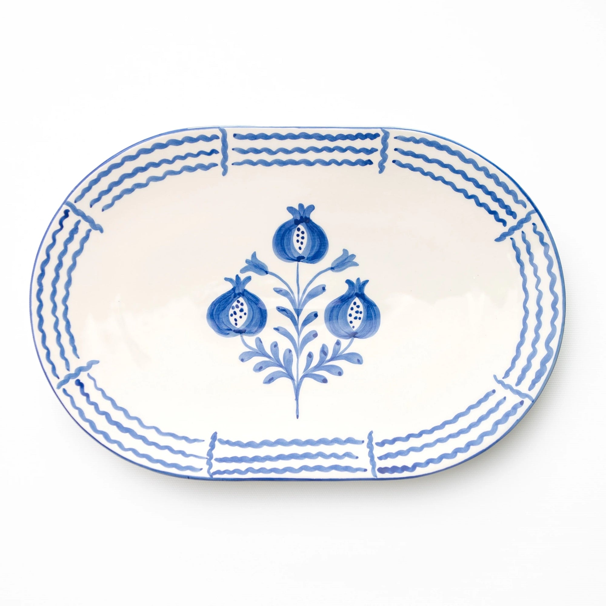 Oval ceramic plate with blue floral design on a white background