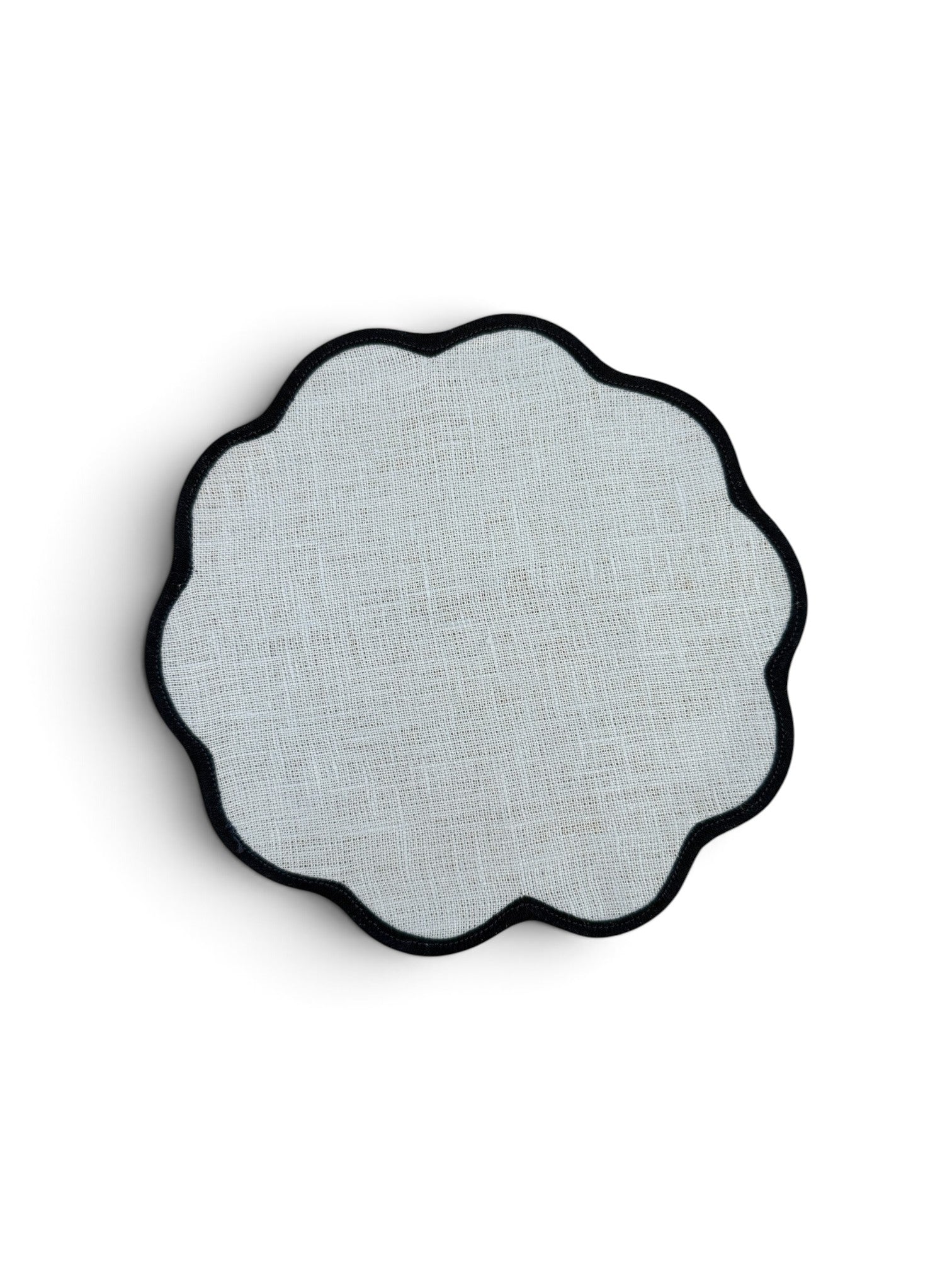 A scalloped circular placemat with a light gray woven linen texture and a black scalloped edge, shown on a white background.