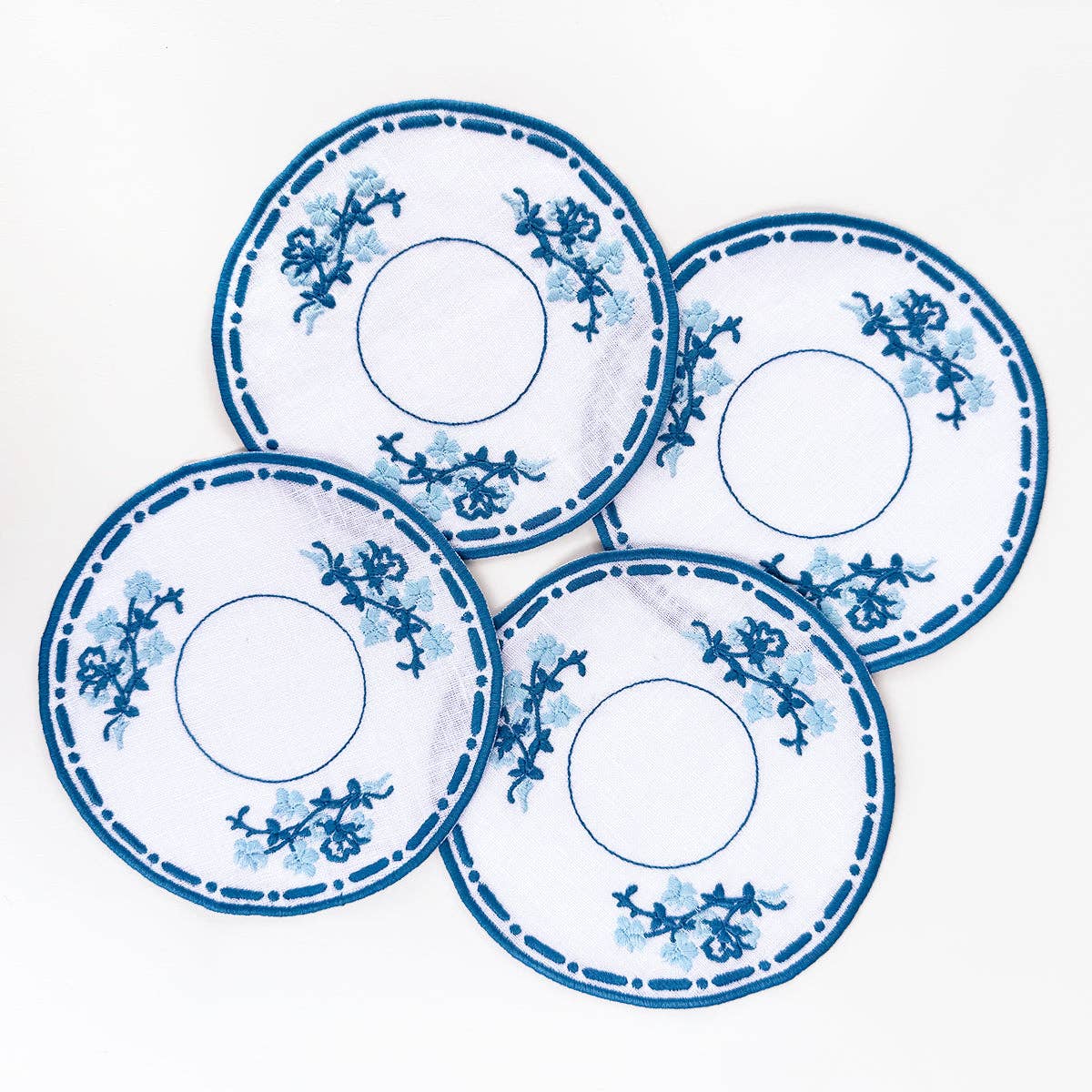Set of 4 willoware embroidered cocktail napkins on white background 