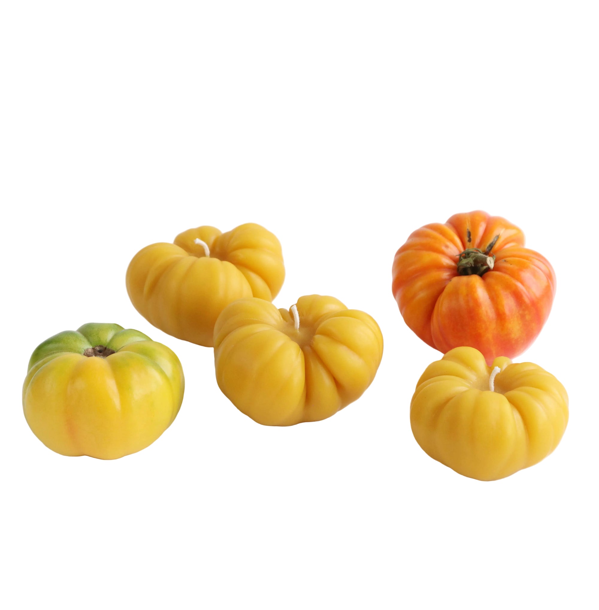 Set of colorful pumpkin-shaped candles on a white background