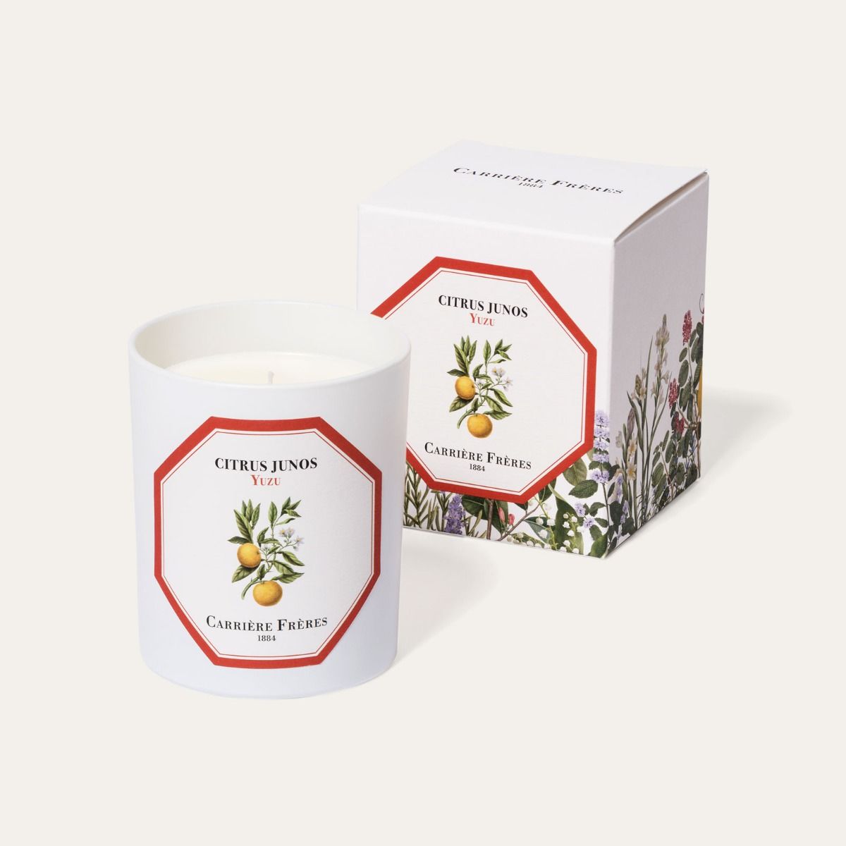 Candle with decorative label and matching box on a white background