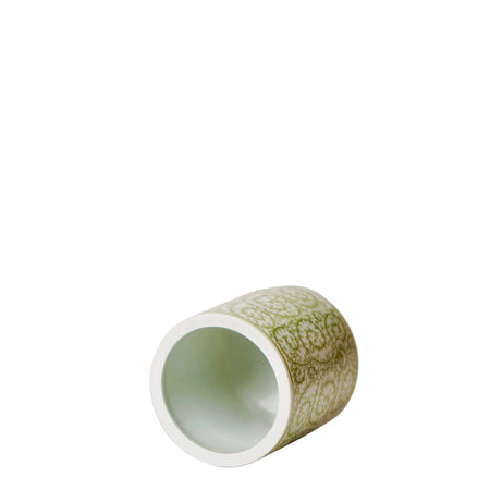 Green ceramic cup with white interior on a white background