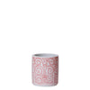 Ceramic mug with red floral pattern on a light gray background