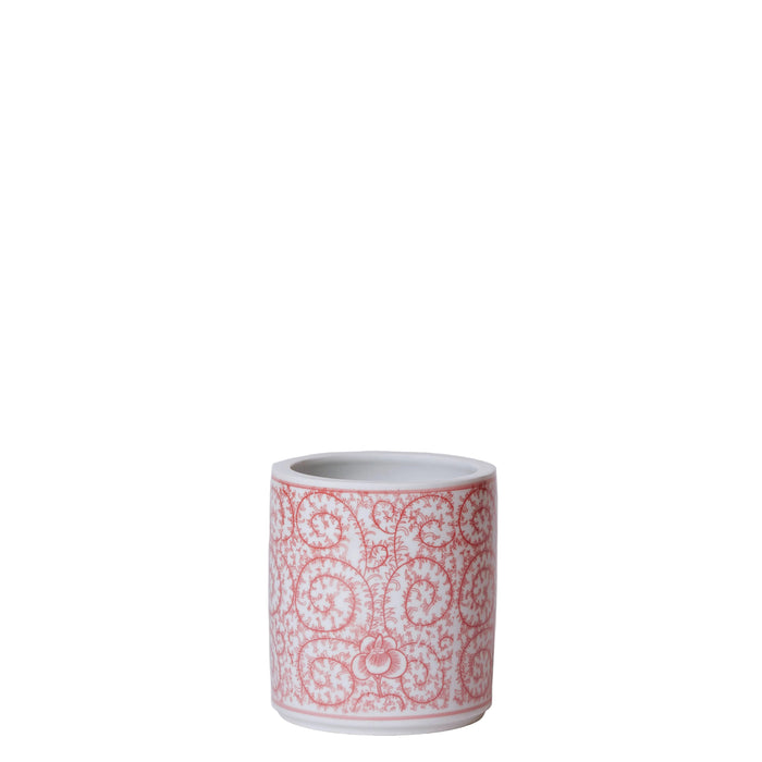 Ceramic mug with red floral pattern on a light gray background
