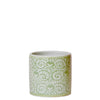 Green and white patterned ceramic container on a white background