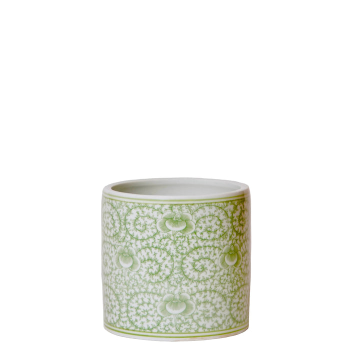 Green and white patterned ceramic container on a white background