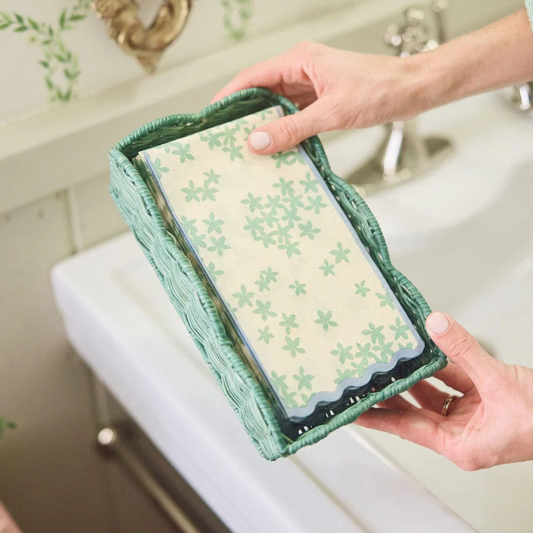 Green rattan holder with napkins and bathroom background