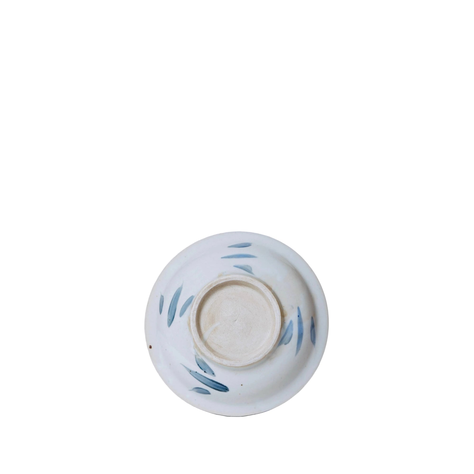 Ceramic bowl with blue leaf patterns on a white background