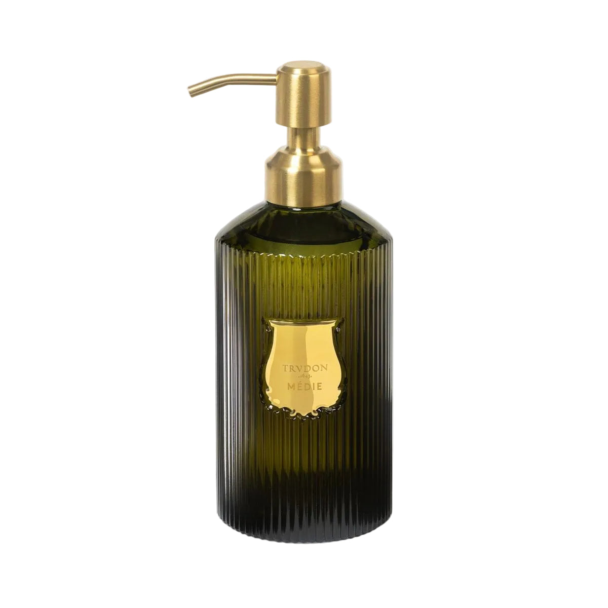 Green soap dispenser with gold pump on a light gray background