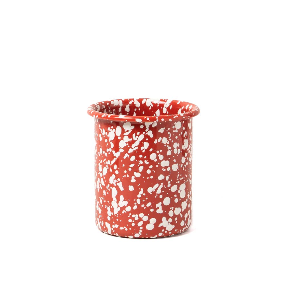 Red ceramic mug with white speckles on a white background