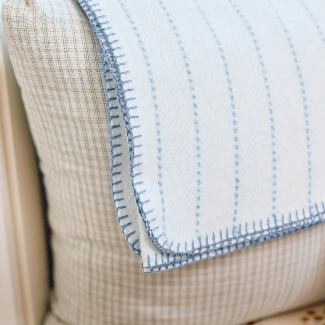 blanket on striped pillow 