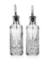 Crystal set of oil and vinegar bottles with stainless steel pour top on white background 